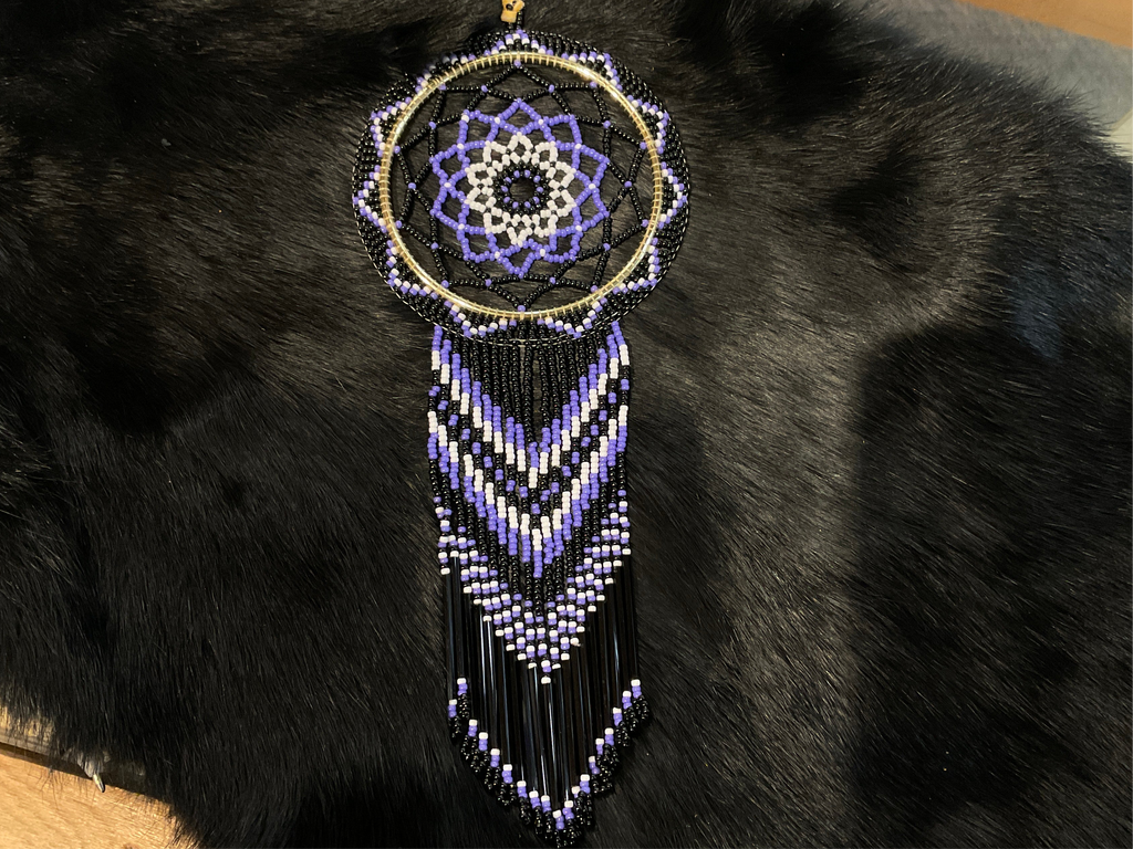 black, purple, and white beaded dream catcher